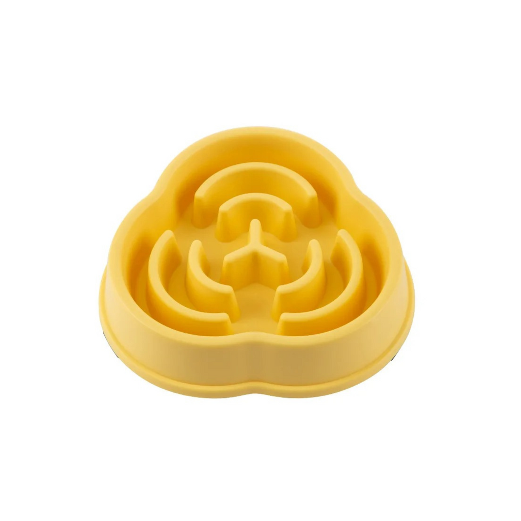 Gamelle anti-glouton jaune en plastique pour chien, forme labyrinthique.