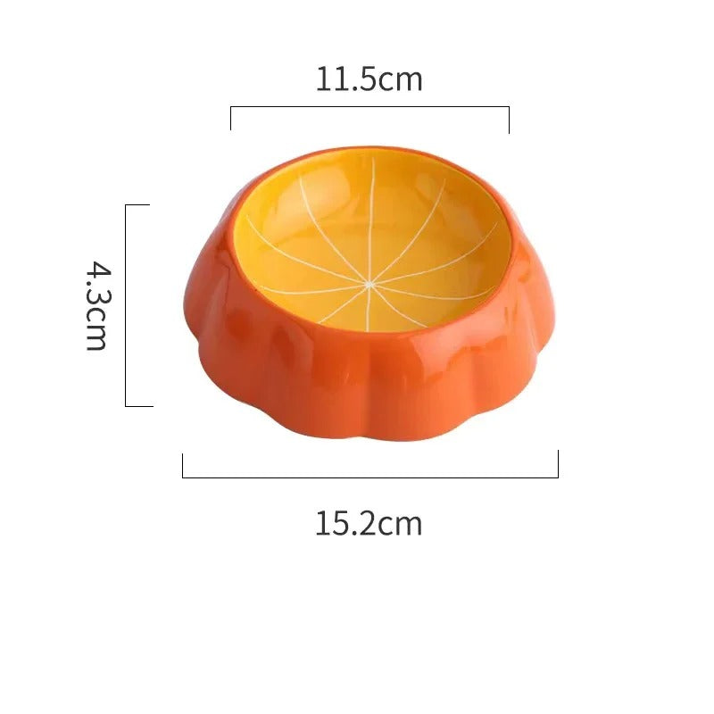 Gamelle en céramique orange en forme de citrouille pour chien, dimensions indiquées.